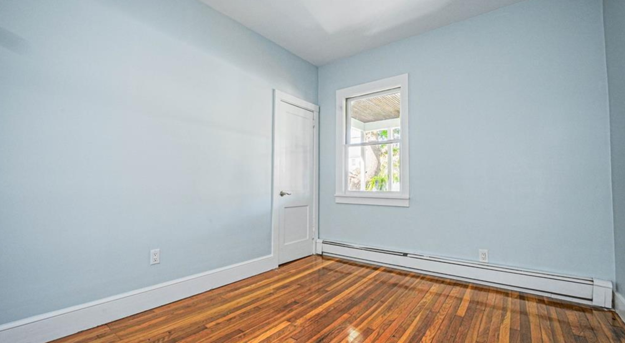 240 Flax Hill Road Norwalk, CT 06854 - Photo 13 of 15 a view of an empty room with wooden floor and a window
