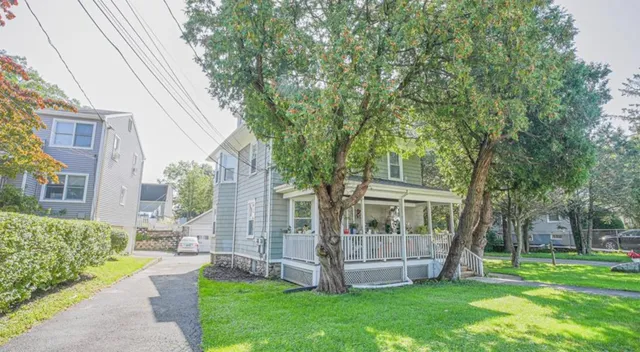 a view of a house with a yard and sitting area