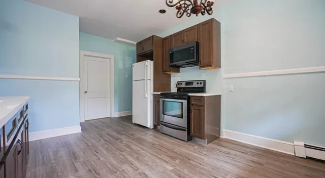 a kitchen with stainless steel appliances a refrigerator microwave and sink