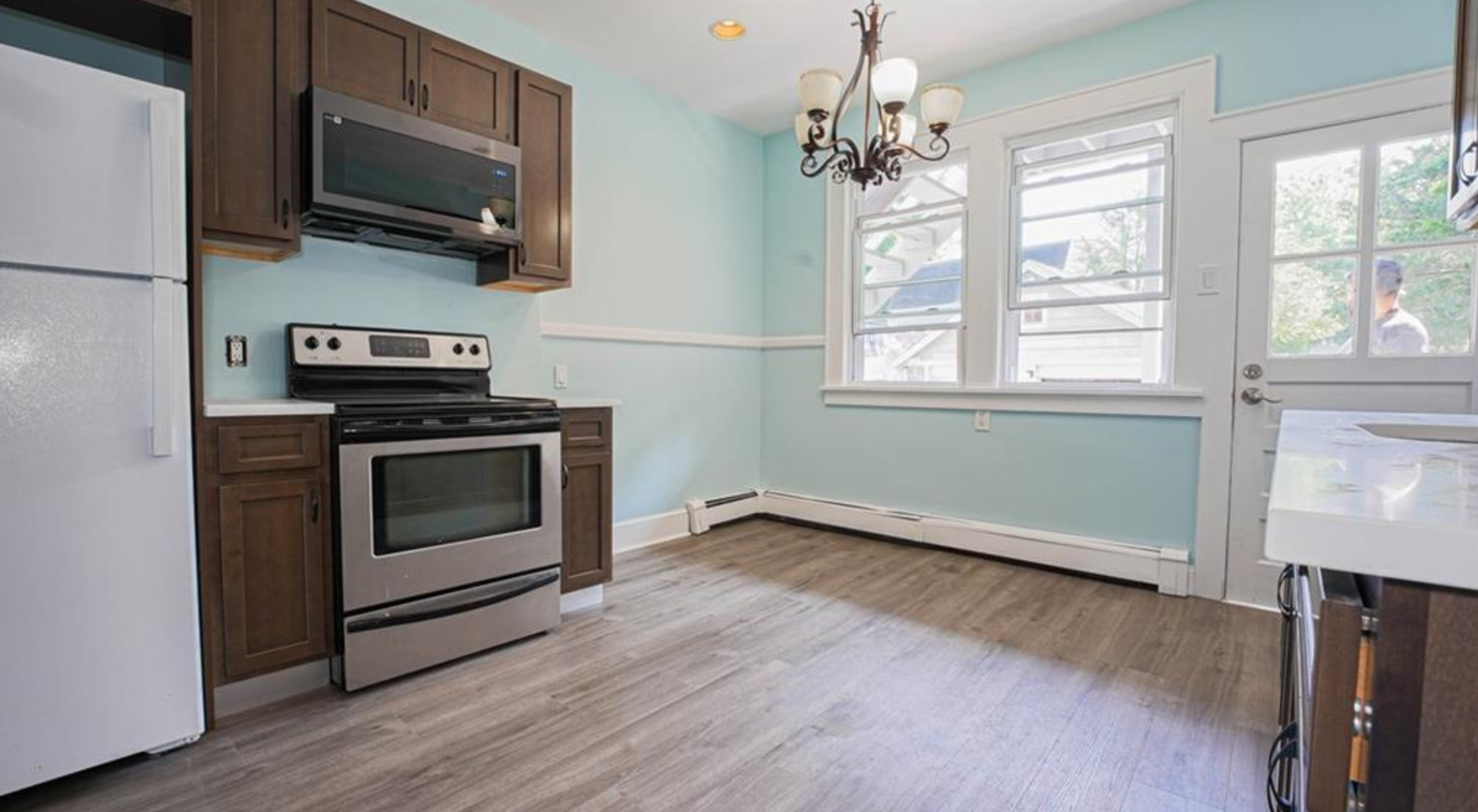 240 Flax Hill Road Norwalk, CT 06854 - Photo 5 of 15 a kitchen with a stove and a microwave
