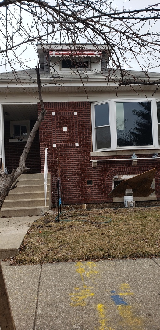 5709 South Mozart Street Chicago, IL 60629 - Photo 1 of 5 a view of house with door