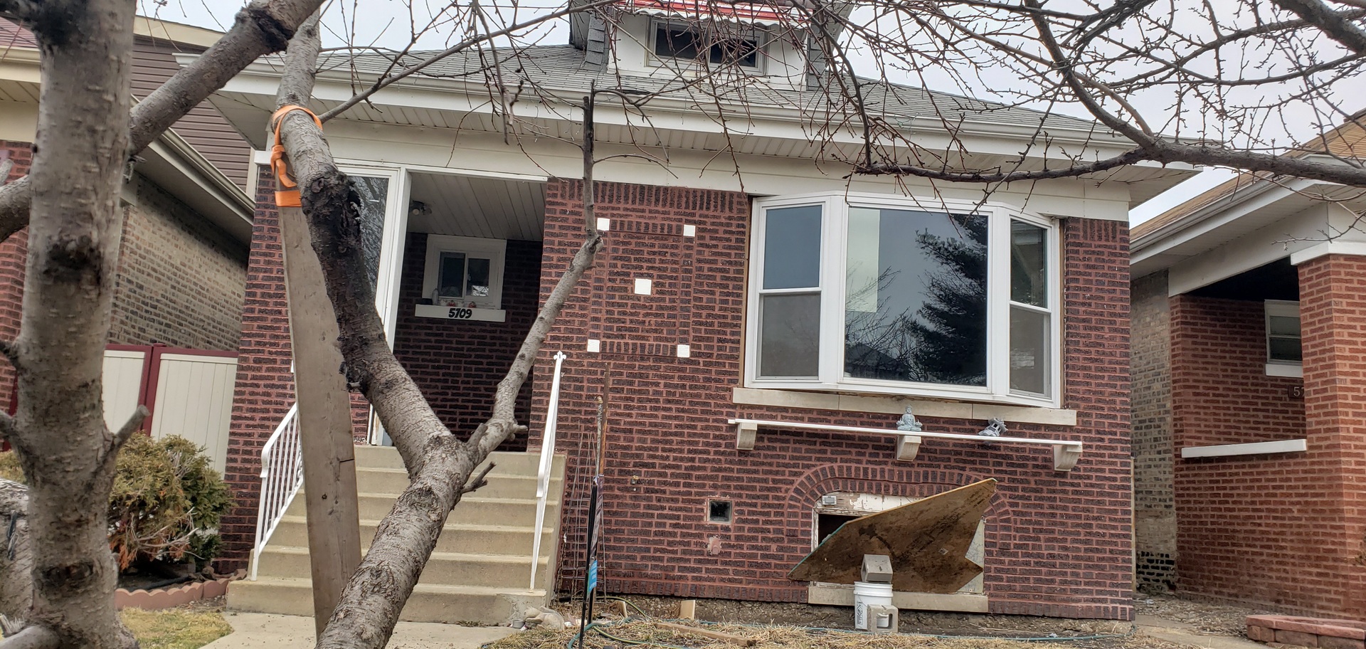 5709 South Mozart Street Chicago, IL 60629 - Photo 2 of 5 a front view of a house with stairs