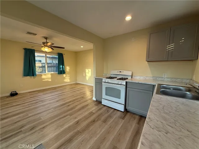 a kitchen with granite countertop a sink and a stove top oven