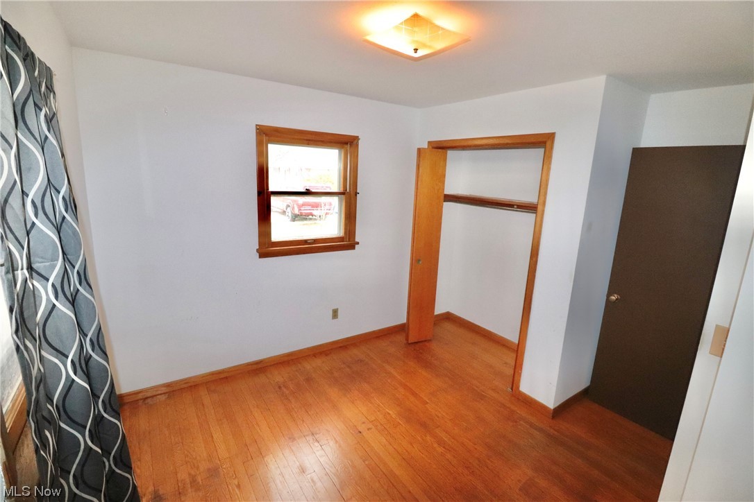 7879 Beach Road Wadsworth, OH 44281 - Photo 21 of 27 Unfurnished bedroom with wood flooring and a closet