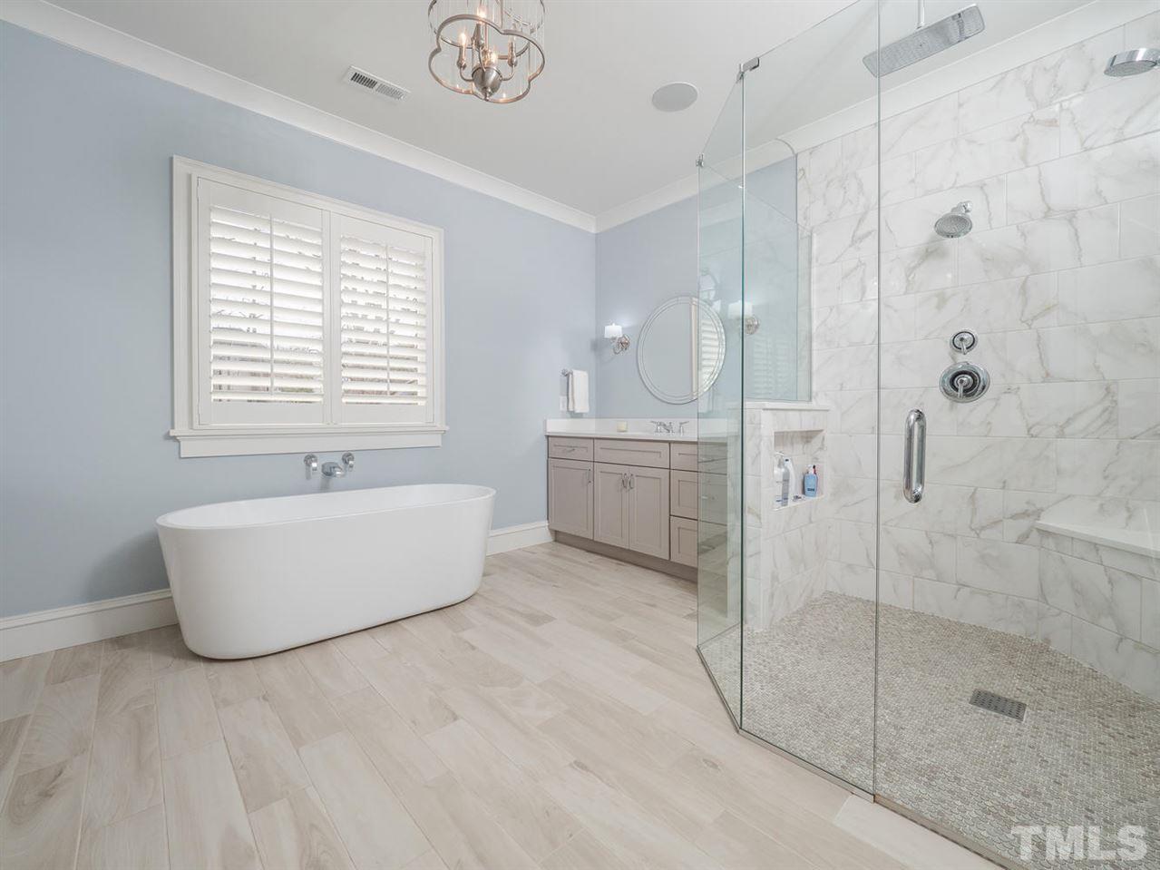 3309 Thomas Road Raleigh, NC 27607 - Photo 22 of 30 This Master Bathroom features a 0 entry shower pan, large rain head shower, a stand alone tub and outlets behind the drawers for extra convenience.