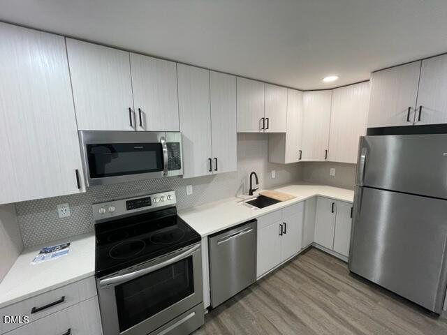 4804 Hoyle Drive, Unit A Raleigh, NC 27604 - Photo 9 of 19 a kitchen with a sink a stove and refrigerator