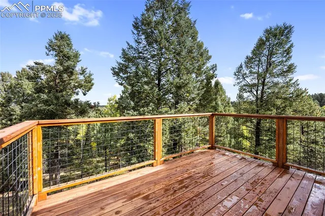 a view of roof deck with wooden floor and fence