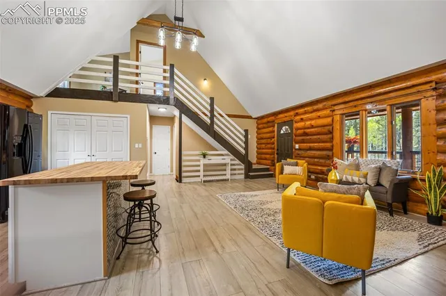 a living room with furniture a dining table and wooden floor