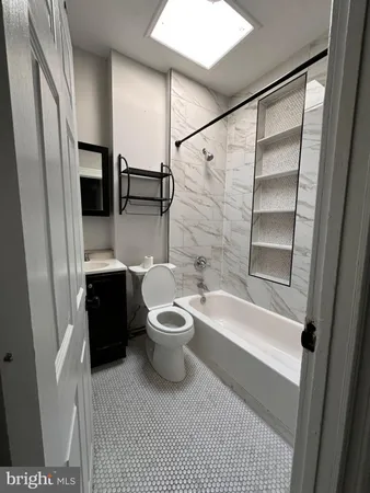 a bathroom with a toilet a sink and bathtub