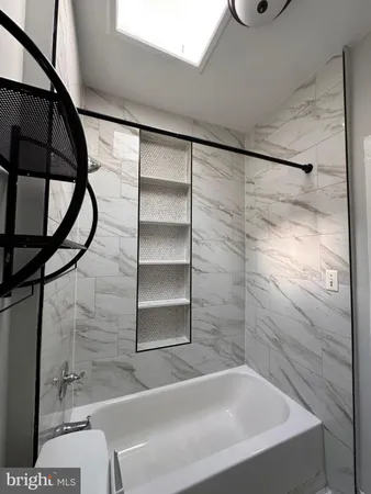 a bathroom with a bathtub and shower