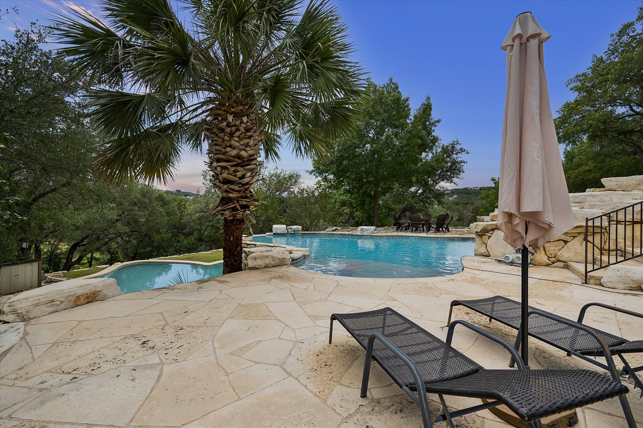3719 Bee Creek Road Spicewood, TX 78669 - Photo 36 of 40 An inviting pool area with natural rock accents and lush surroundings provides a perfect oasis.