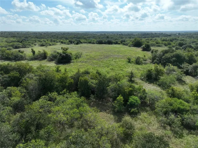 an aerial view of a houses with a yard