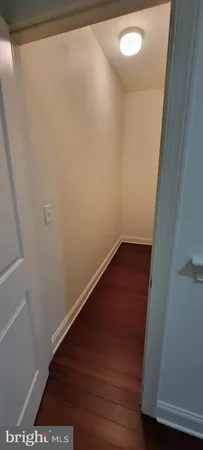 a view of hallway with wooden floor