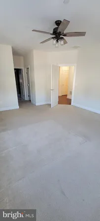a view of a livingroom with a ceiling fan and window