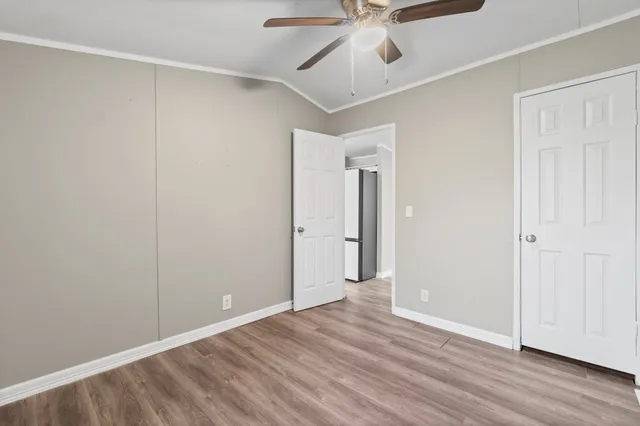 a view of an empty room with wooden floor