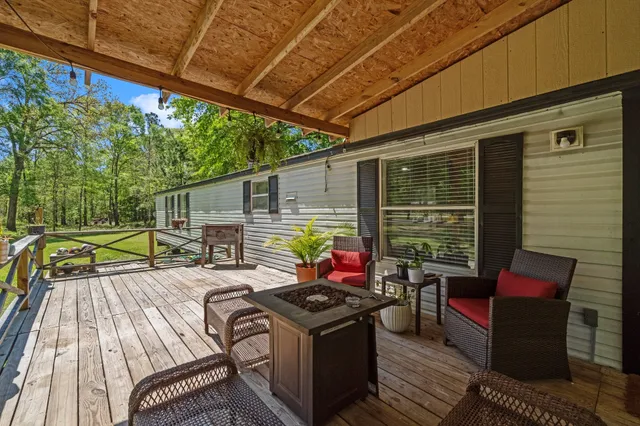 a view of a patio with a table chairs and a backyard