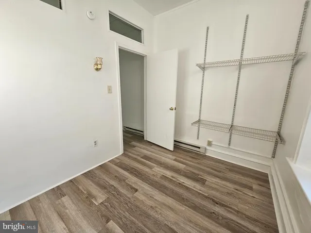 a view of a room with wooden floor