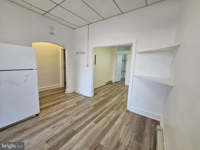 a view of a room with wooden floor