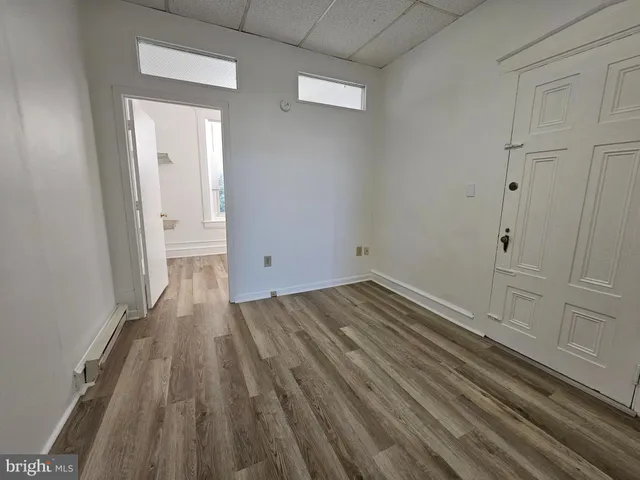 a view of a room with wooden floor