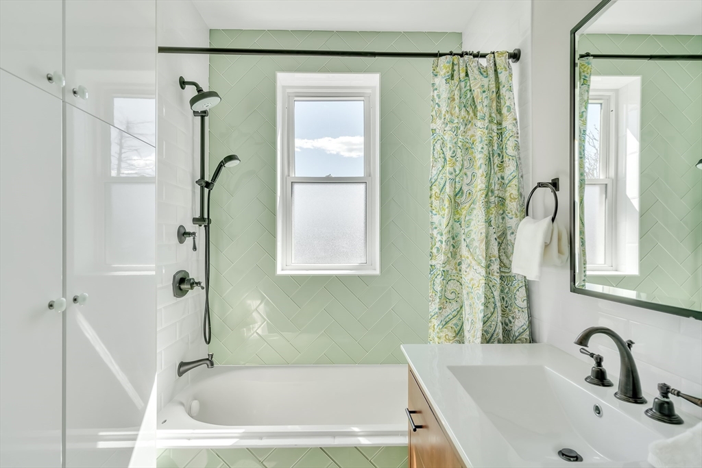 20 John Street, Unit 3 Brookline, MA 02446 - Photo 11 of 23 a bathroom with a tub shower and a sink
