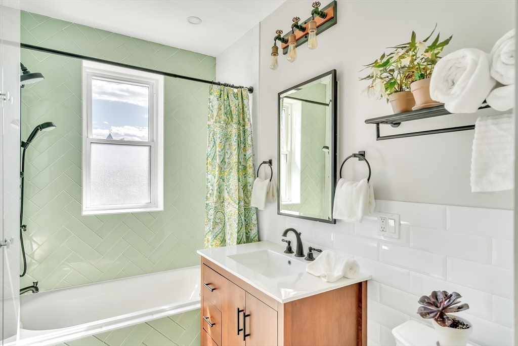 20 John Street, Unit 3 Brookline, MA 02446 - Photo 12 of 23 a bathroom with a sink a bathtub and a mirror