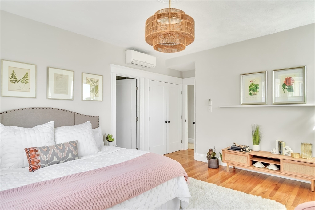 20 John Street, Unit 3 Brookline, MA 02446 - Photo 16 of 23 a bedroom with a bed and a chandelier