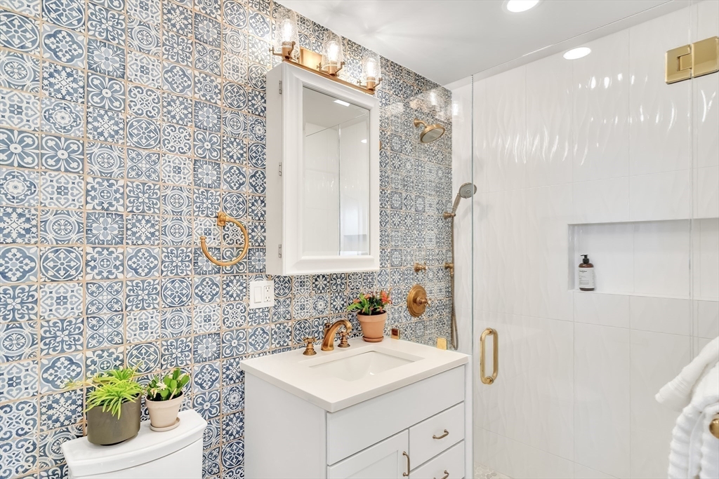 20 John Street, Unit 3 Brookline, MA 02446 - Photo 18 of 23 a bathroom with a sink a toilet and shower