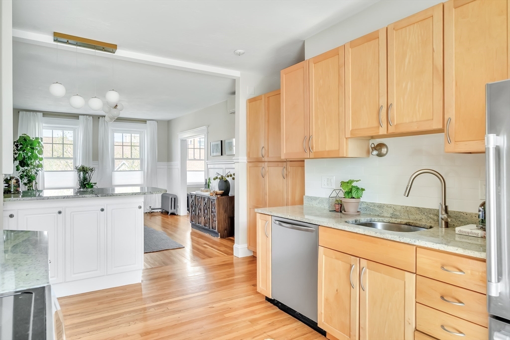 20 John Street, Unit 3 Brookline, MA 02446 - Photo 8 of 23 a kitchen with granite countertop a sink stainless steel appliances and cabinets