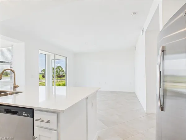 a kitchen with refrigerator and window
