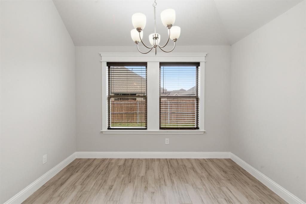 972 Sam Street Springtown, TX 76082 - Photo 12 of 34 an empty room with wooden floor and windows