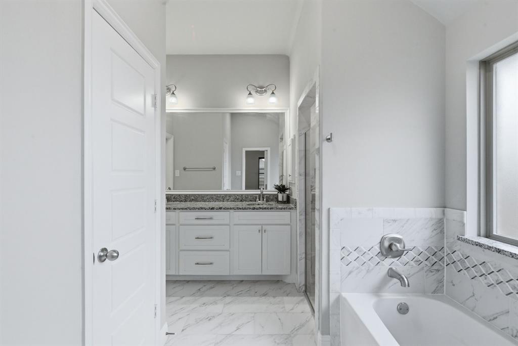 972 Sam Street Springtown, TX 76082 - Photo 18 of 34 a bathroom with a tub sink and mirror