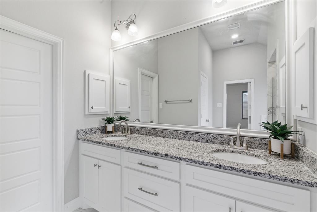 972 Sam Street Springtown, TX 76082 - Photo 20 of 34 a bathroom with a granite countertop sink and a mirror