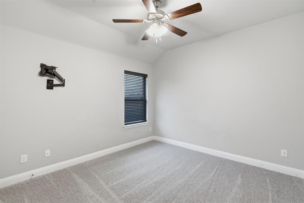 972 Sam Street Springtown, TX 76082 - Photo 22 of 34 an empty room with a window and a fan