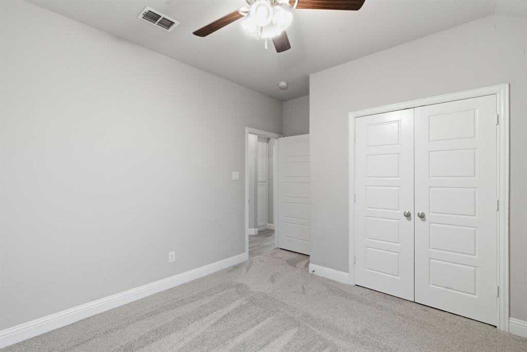 972 Sam Street Springtown, TX 76082 - Photo 23 of 34 an empty room with chandelier fan