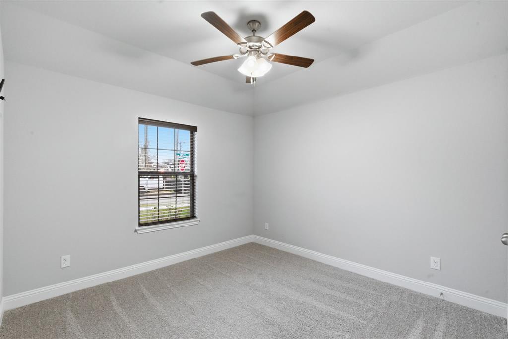 972 Sam Street Springtown, TX 76082 - Photo 25 of 34 an empty room with windows and ceiling fan