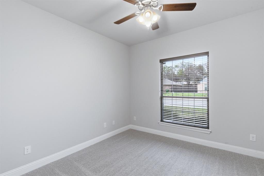 972 Sam Street Springtown, TX 76082 - Photo 27 of 34 an empty room with a window and ceiling fan