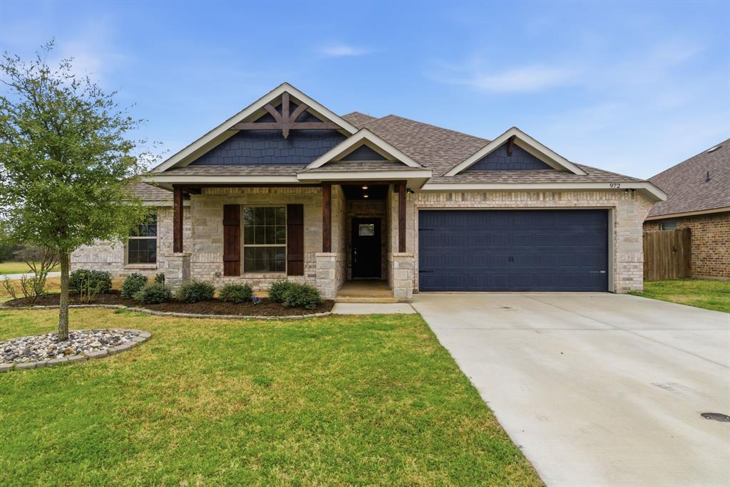 972 Sam Street Springtown, TX 76082 - Photo 29 of 34 a front view of a house with a yard and garage