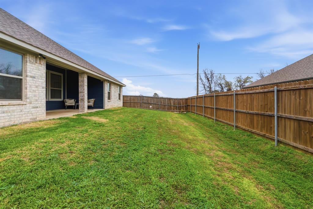 972 Sam Street Springtown, TX 76082 - Photo 33 of 34 a view of a backyard with table and chairs