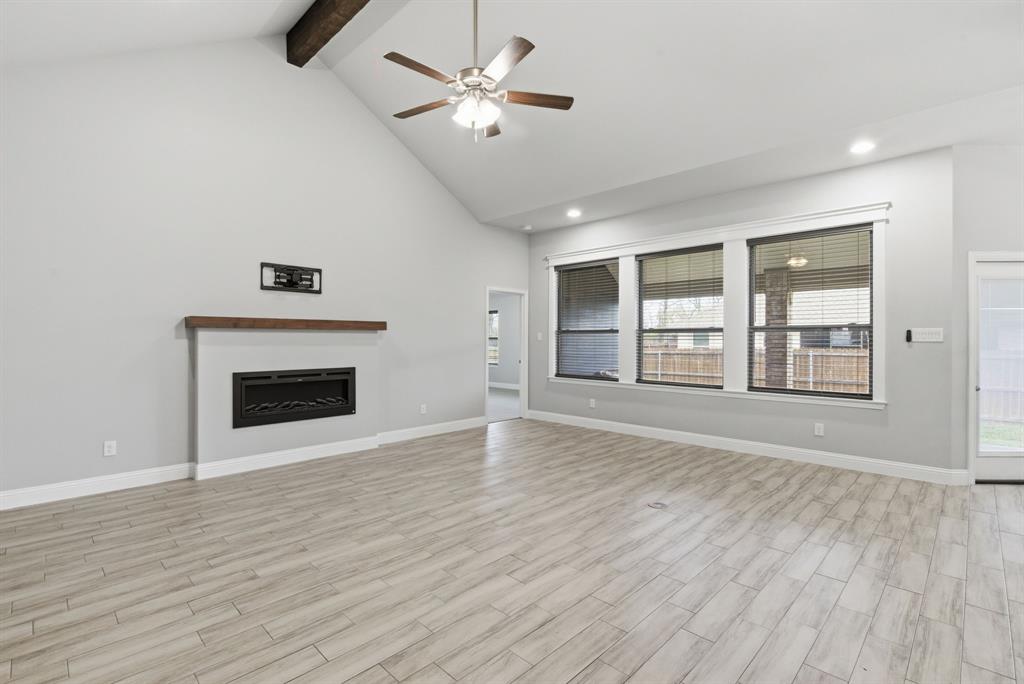 972 Sam Street Springtown, TX 76082 - Photo 6 of 34 a view of an empty room with a fireplace and a window