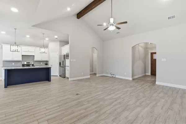 a view of kitchen with refrigerator and window