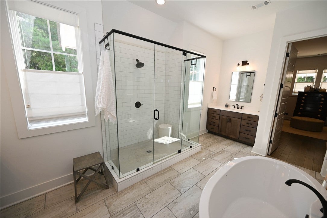 2865 Pear Tree Road Auburn, AL 36879 - Photo 27 of 49 Primary bathroom with dual vanities, extra-deep soaking tub, oversized glass shower, & (of course!) more windows!! Back right: primary closet.