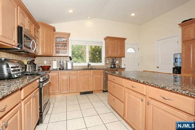 84 12th Street Cresskill, NJ 07626 - Photo 18 of 45 a kitchen with stainless steel appliances granite countertop a sink counter space cabinets and a large window
