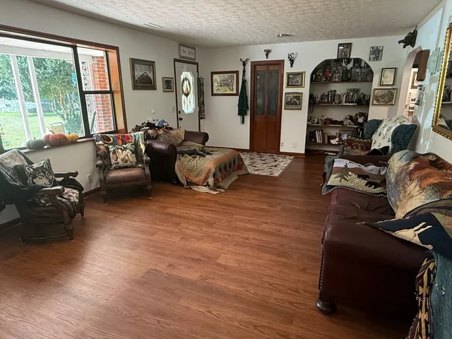 a living room with furniture fireplace and a flat screen tv