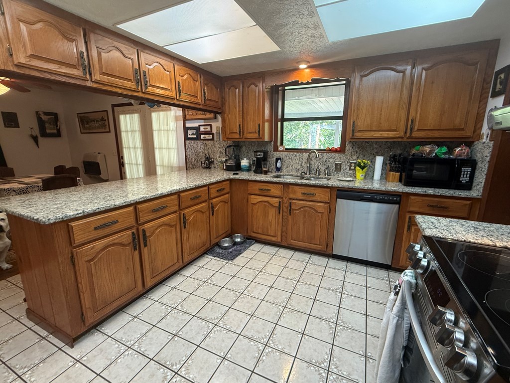 10809 Beaver Dam Road Murphy, NC 28906 - Photo 18 of 46 a kitchen with stainless steel appliances granite countertop a stove sink and cabinets