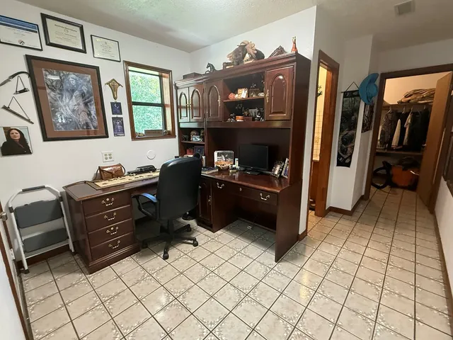a bathroom with a granite countertop toilet and a shower