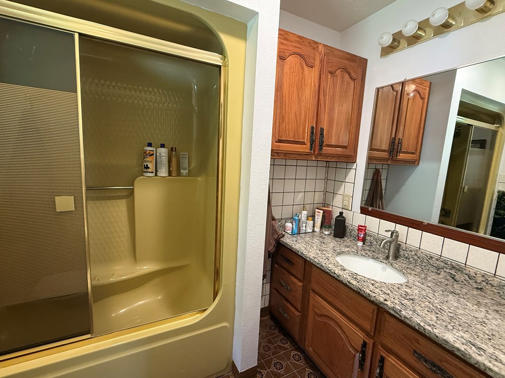 10809 Beaver Dam Road Murphy, NC 28906 - Photo 24 of 46 a bathroom with a granite countertop sink and a mirror
