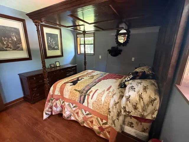 a bed sitting in a bedroom next to a window