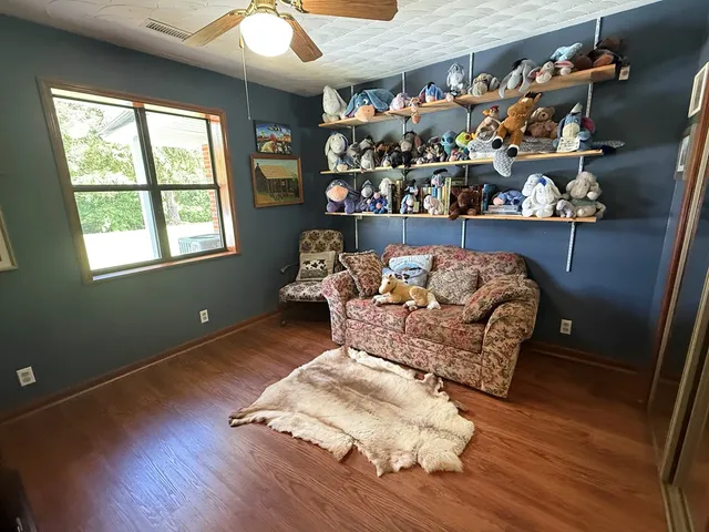 a living room with furniture and a floor to ceiling window