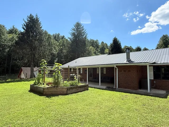 a view of a house with backyard porch and sitting area