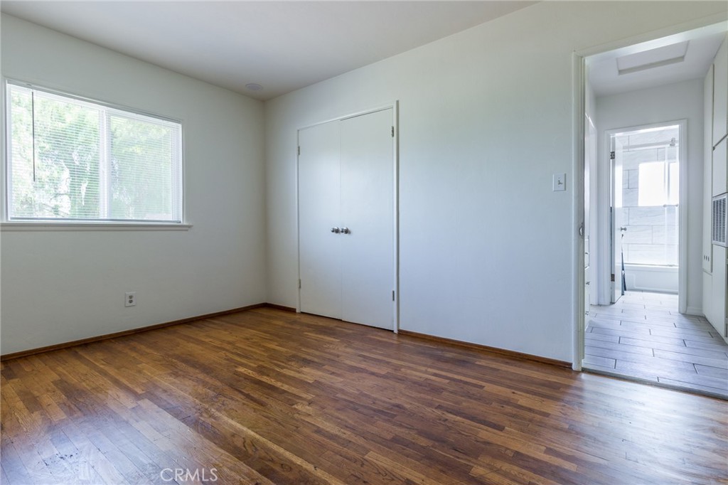 5923 Tyler Street Riverside, CA 92503 - Photo 13 of 19 a view of an empty room with wooden floor and a window
